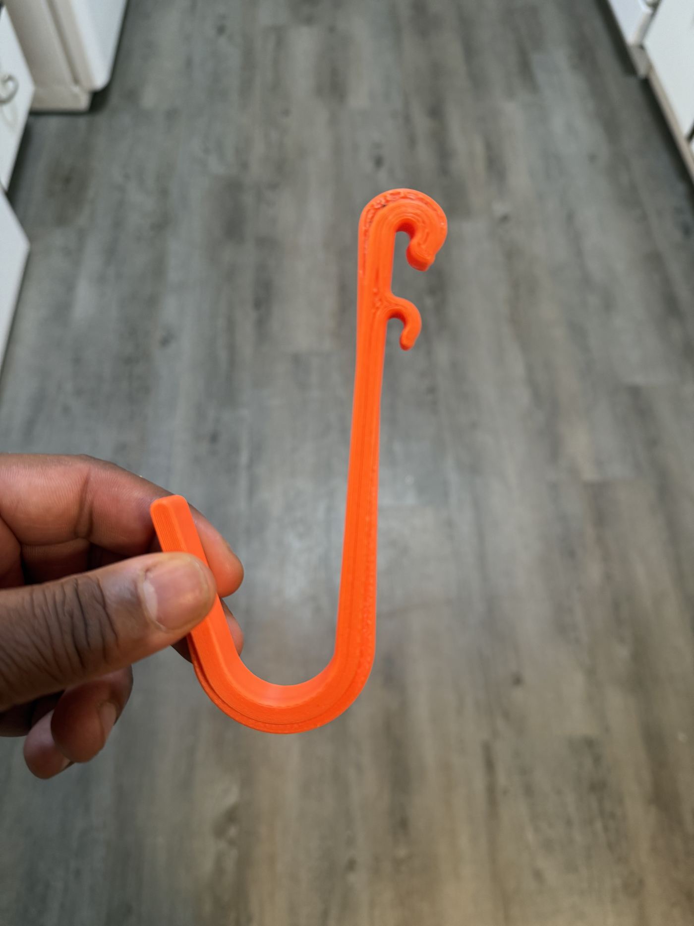 Flexible orange S-shaped cord hook
