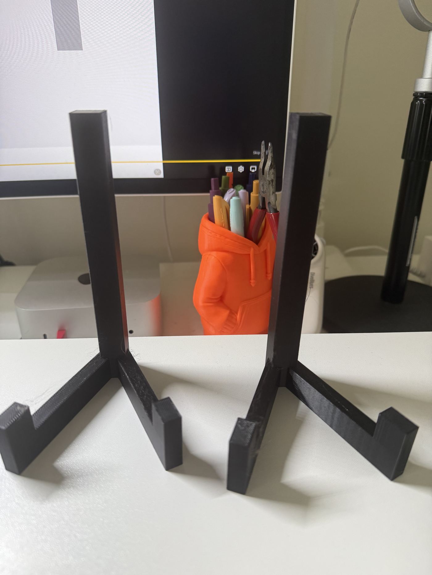 Two-post monitor stand with a built-in tool and pen tray